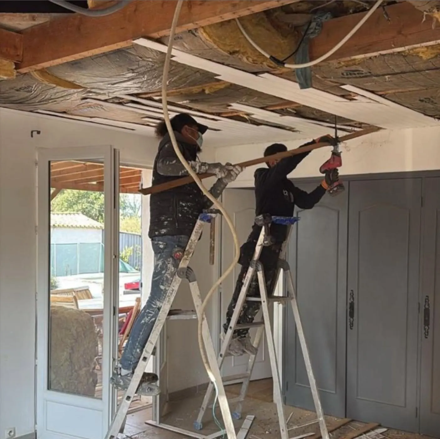 Deux plaquistes HOME RENOV posent un faux plafond
