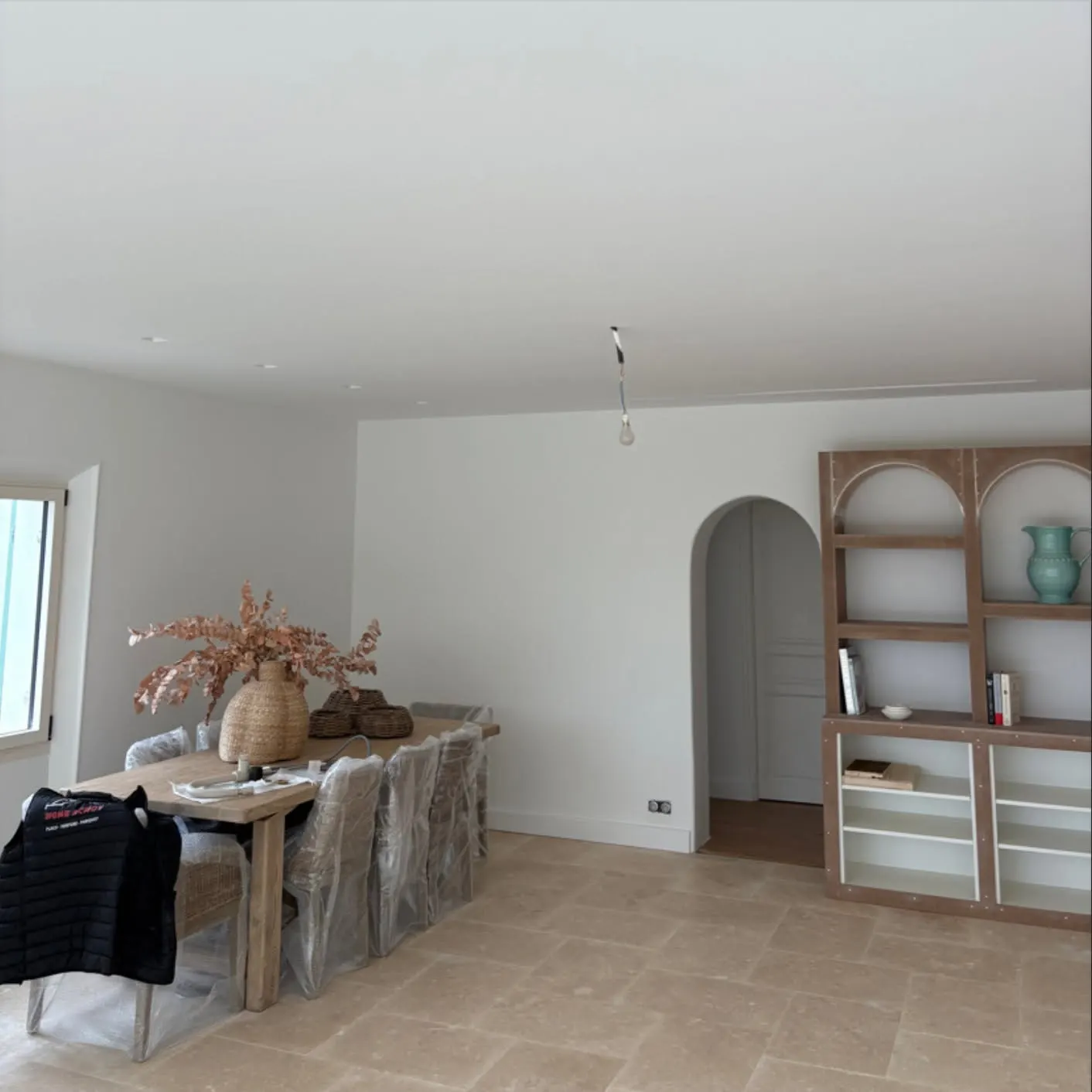 Salon rénové avec arche et bibliothèque sur mesure